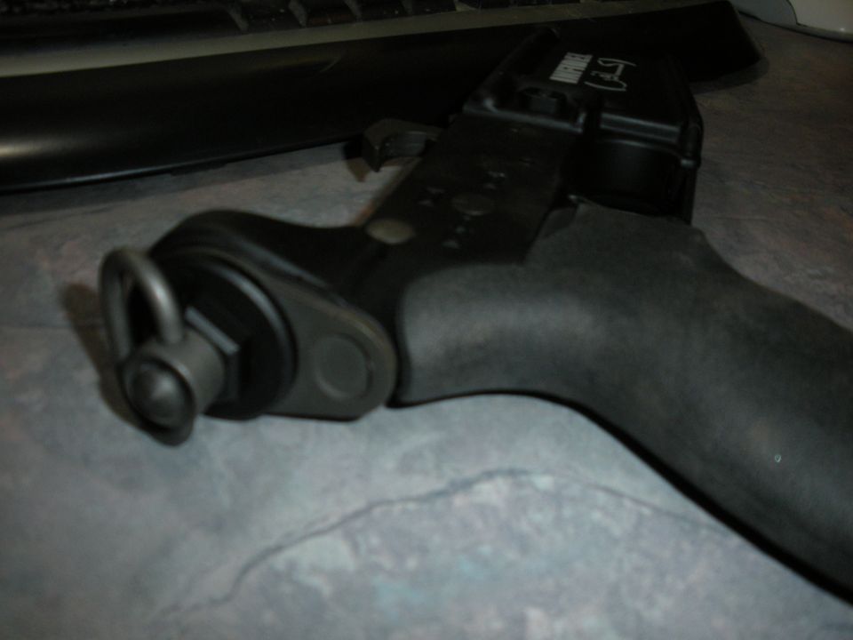 close-up of a black tool part with a ring and bolt