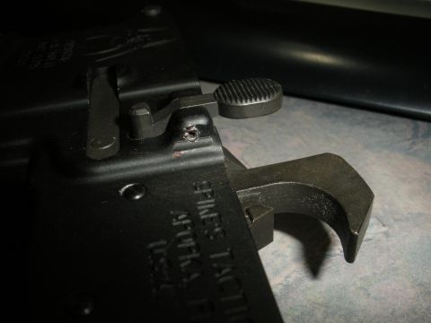 1996 Ford Bronco - Close-up of a firearm part, possibly a selector switch, with visible text indicating 'SPIKES TACTICAL'.