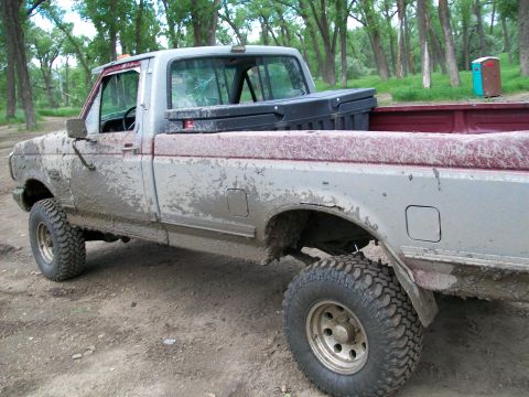 1988 Ford F-150 - This pickup truck is covered in mud, suggesting it has been off-roading.