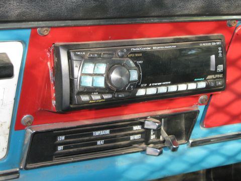 1972 Ford F-250 - Interior view of a car's dashboard showing climate controls and an aftermarket stereo unit.