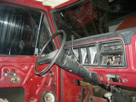1979 Ford Bronco - The interior of a vehicle is shown with the door panel removed, revealing the inner workings.