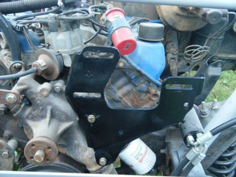 1978 Ford Bronco - Close-up of a Ford V8 engine, showing engine components and a black mounting bracket.