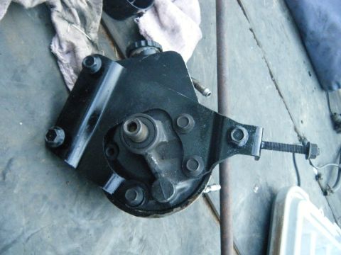 1978 Ford Bronco - This black power steering pump assembly is shown with its mounting bracket and adjustment bolt visible.