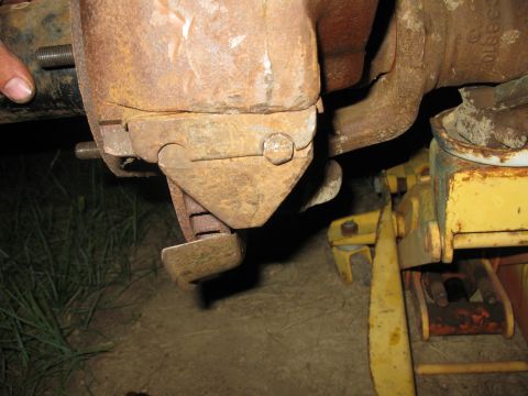 1978 Ford Bronco - This image shows a close-up of a heavily rusted vehicle component, likely part of the suspension or braking system.