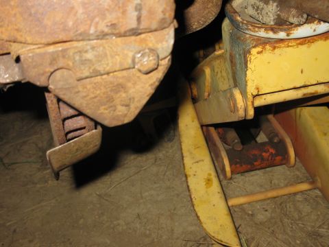 1978 Ford Bronco - A close-up view of heavily rusted metal parts and a yellow jack, with a website address visible at the bottom.