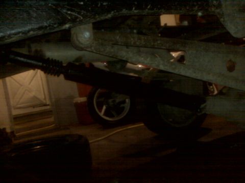 1994 Ford F-250 - The underside of a vehicle is captured, showing mechanical components and a wheel.