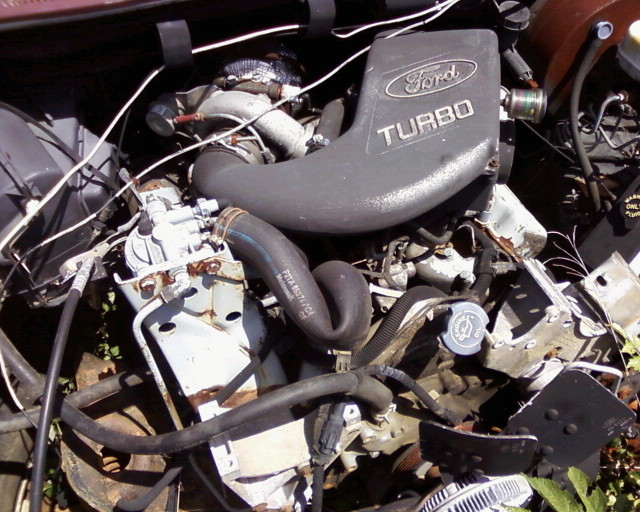 Ford turbo engine with hoses and wiring visible
