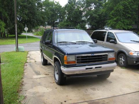 1991 Ford Explorer - This 1991 Ford Explorer is parked in a driveway next to another vehicle.