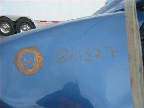 2005 Dodge 3500 - A blue vehicle panel shows orange markings, including a circle with a V and a sequence of numbers.