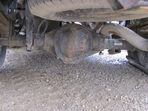 2005 Dodge 3500 - Undercarriage view of a truck's rear axle and suspension system, including the differential and exhaust.