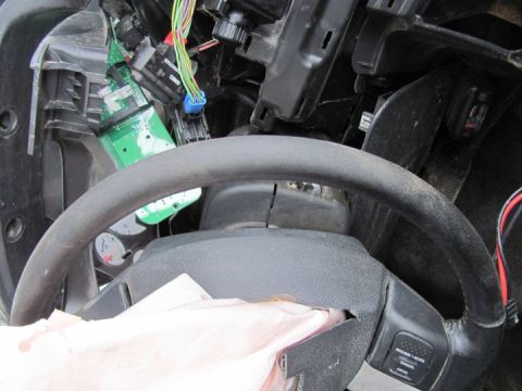 2005 Dodge 3500 - Interior view of a 2005 Dodge 3500 with a deployed airbag and damaged dashboard components.