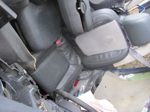 2005 Dodge 3500 - The interior of the vehicle shows black leather seats and a gray center console with a Ram logo.
