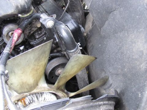 2005 Dodge 3500 - Close-up view of engine components including fan blades and pulleys.