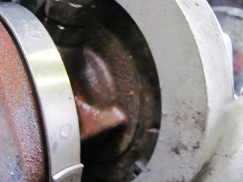 2005 Dodge 3500 - A close-up view of an engine's internal components, specifically a bearing and crankshaft, showing wear and discoloration.