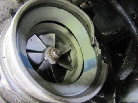 2005 Dodge 3500 - The impeller blades of a turbocharger are visible within its housing, showing signs of wear and damage.