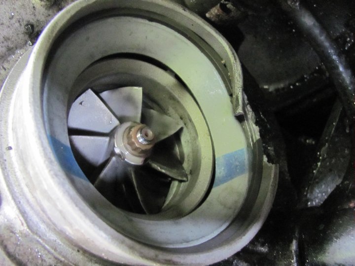 Close-up of a turbocharger impeller with some damage to the housing