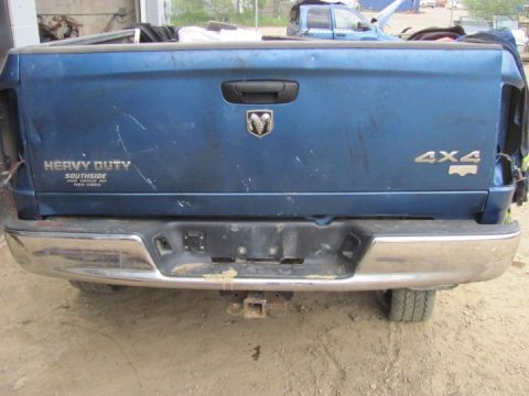 2005 Dodge 3500 - Rear view of a blue 2005 Dodge 3500 pickup truck, showing the tailgate and chrome bumper.
