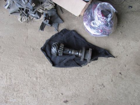 2005 Dodge 3500 - A differential gear and shaft assembly rests on a black cloth on a concrete floor.