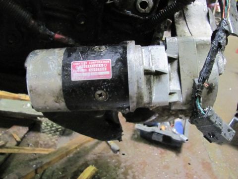 2005 Dodge 3500 - Starter motor assembly with a visible Chrysler Corporation label and part numbers.