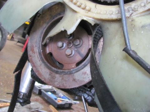 2005 Dodge 3500 - Close-up of a damaged engine fan blade and pulley assembly, showing mechanical components.