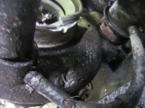 2005 Dodge 3500 - Close-up of a greasy engine component with visible hoses and metal parts.