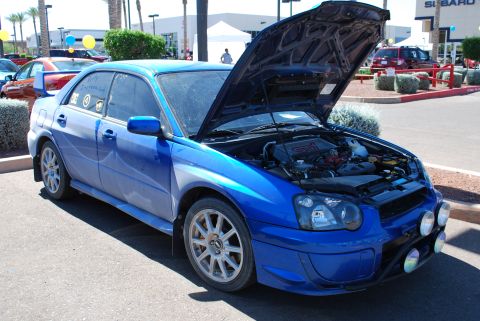 2005 Subaru Impreza - Blue 2005 Subaru Impreza WRX STI at a car show with hood open.