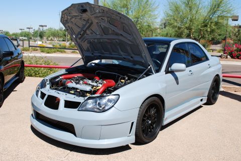 2005 Subaru Impreza - A light gray Subaru Impreza WRX is parked outside with its hood open, revealing the engine bay.