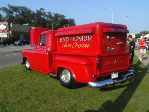 1960 Ford Falcon - A vintage red ice cream truck is parked on a grassy area with its hood open.