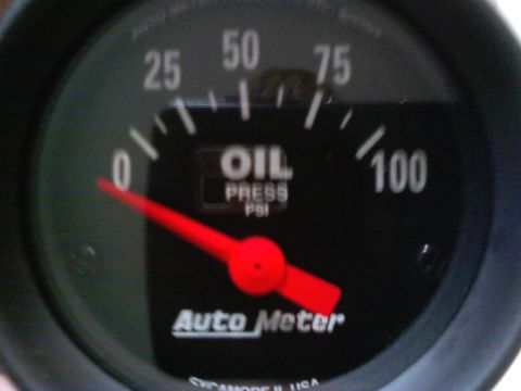 1990 Ford Bronco - Close-up of an Auto Meter oil pressure gauge showing 0 PSI, indicating a potential issue or a specific engine state.