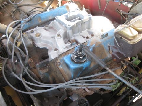 1978 Ford Bronco - Close-up view of an engine bay, focusing on the carburetor and associated wiring.