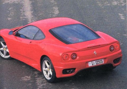 1998 Ford Crown Victoria - A red Ferrari 360 Modena is shown from the rear on a wet road surface.