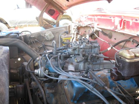 1978 Ford Bronco - Close-up view of the engine bay, focusing on the carburetor and associated wiring.