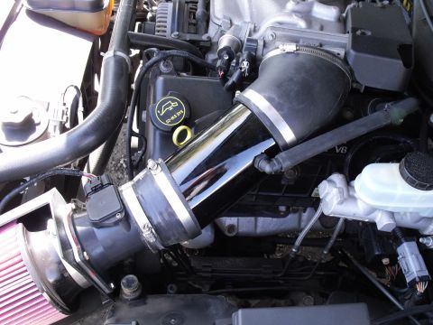 2003 Mercury Marauder - Close-up of an engine bay an aftermarket intake system and a visible V8 designation.