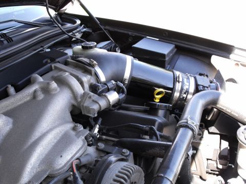 2003 Mercury Marauder - Close-up of a car's engine bay, focusing on the intake system and various engine components.