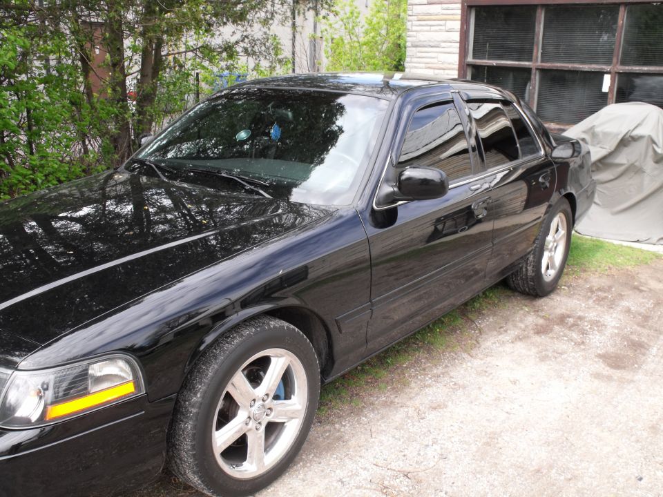 Black 2003 Mercury Marauder parked outside a garage