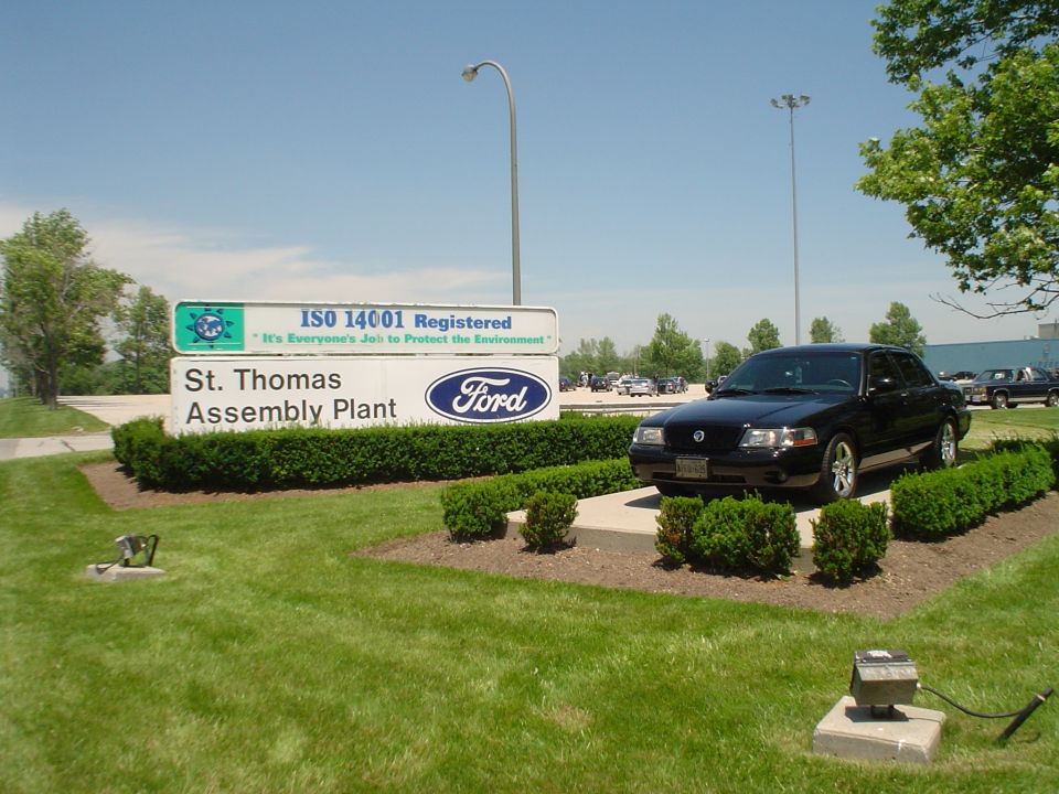 Black sedan parked in front of St. Thomas Assembly Plant sign