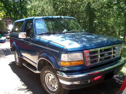1995 Ford Bronco - This 1995 Ford Bronco is shown from a three-quarter front view, parked in a driveway.
