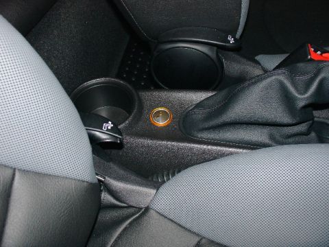 2003 Ford Crown Victoria - Interior view of a car's center console, a cup holder and gear shift area.