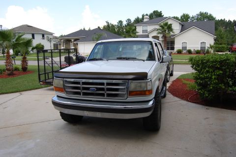 1994 Ford Bronco - This white Ford truck, likely from the mid-1990s, is shown from the front in a driveway.