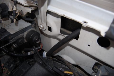 1994 Ford Bronco - Close-up view of engine bay components, including wiring harnesses and an ABS module.