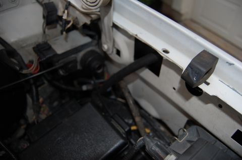 1994 Ford Bronco - Engine bay wiring and hoses are visible, along with a rubber stopper on the frame.