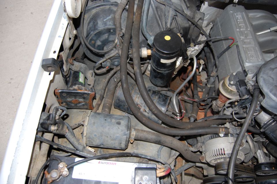 1994 Ford Bronco engine bay with visible Autocraft battery and Supermotors.net watermark