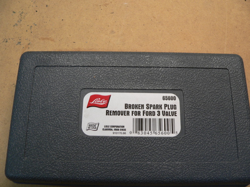 Gray plastic case with a label that says Lisle, broken spark plug remover for Ford 3 valve, and a barcode