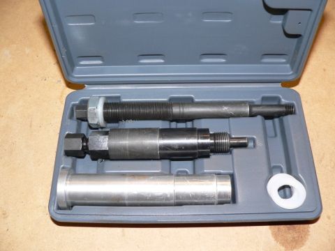 2007 Ford Mustang - A set of automotive tools, including a threaded rod, a cylindrical tool with a hexagonal end, and a larger cylindrical component, are neatl…