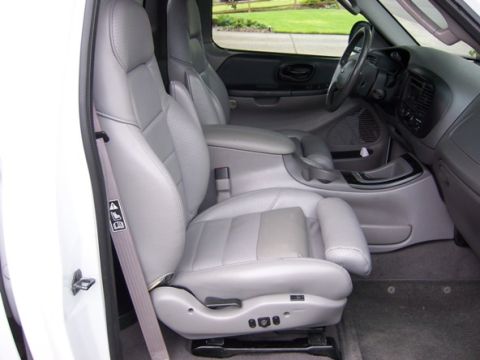 2007 Ford Mustang - Interior view of a truck's front seats and dashboard area.