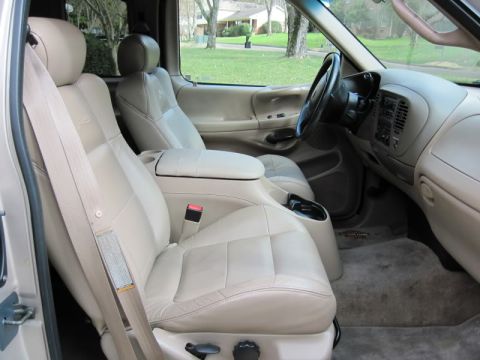2007 Ford Mustang - The interior of a beige truck, leather seats and a dashboard view.