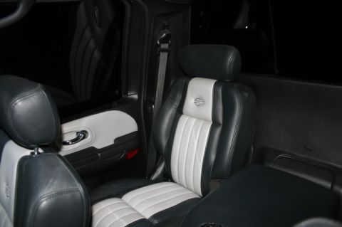 2007 Ford Mustang - The interior of a vehicle shows custom two-tone leather seats with a Harley-Davidson emblem.