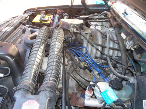 1995 Ford Bronco - Close-up view of the engine compartment, showing the air intake system and electrical components.