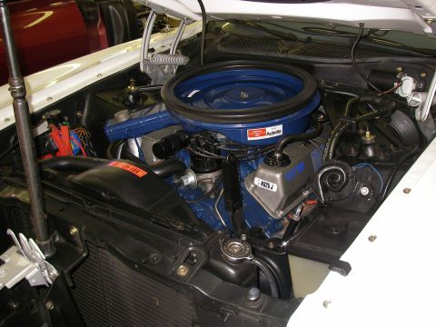 1971 Ford Mustang - Close-up of the engine compartment of a 1971 Ford Mustang, highlighting the V8 engine components.
