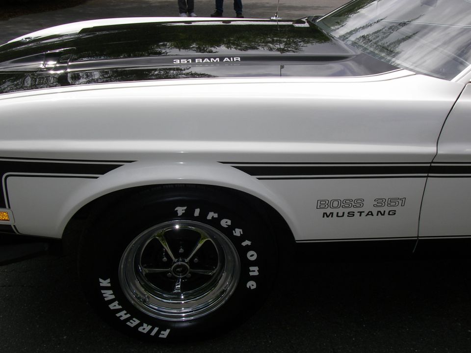 White 1971 Ford Mustang Boss 351 side view, black stripe, chrome wheels, Firestone tires, hood scoop reads 351 RAM AIR